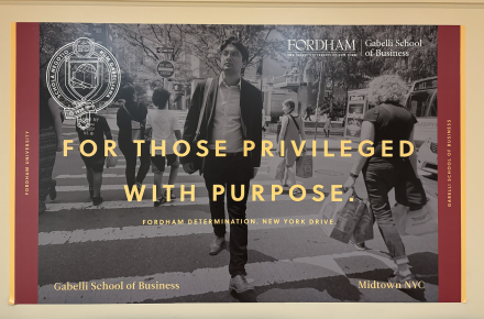 A poster for Fordham’s Gabelli School of Business features a man confidently walking in New York City with the slogan “For Those Privileged With Purpose.”